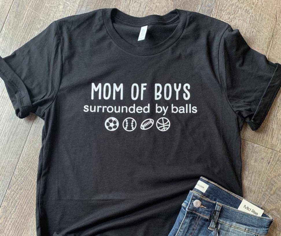 Mom of boys surrounded by balls - Football, basketball, baseball