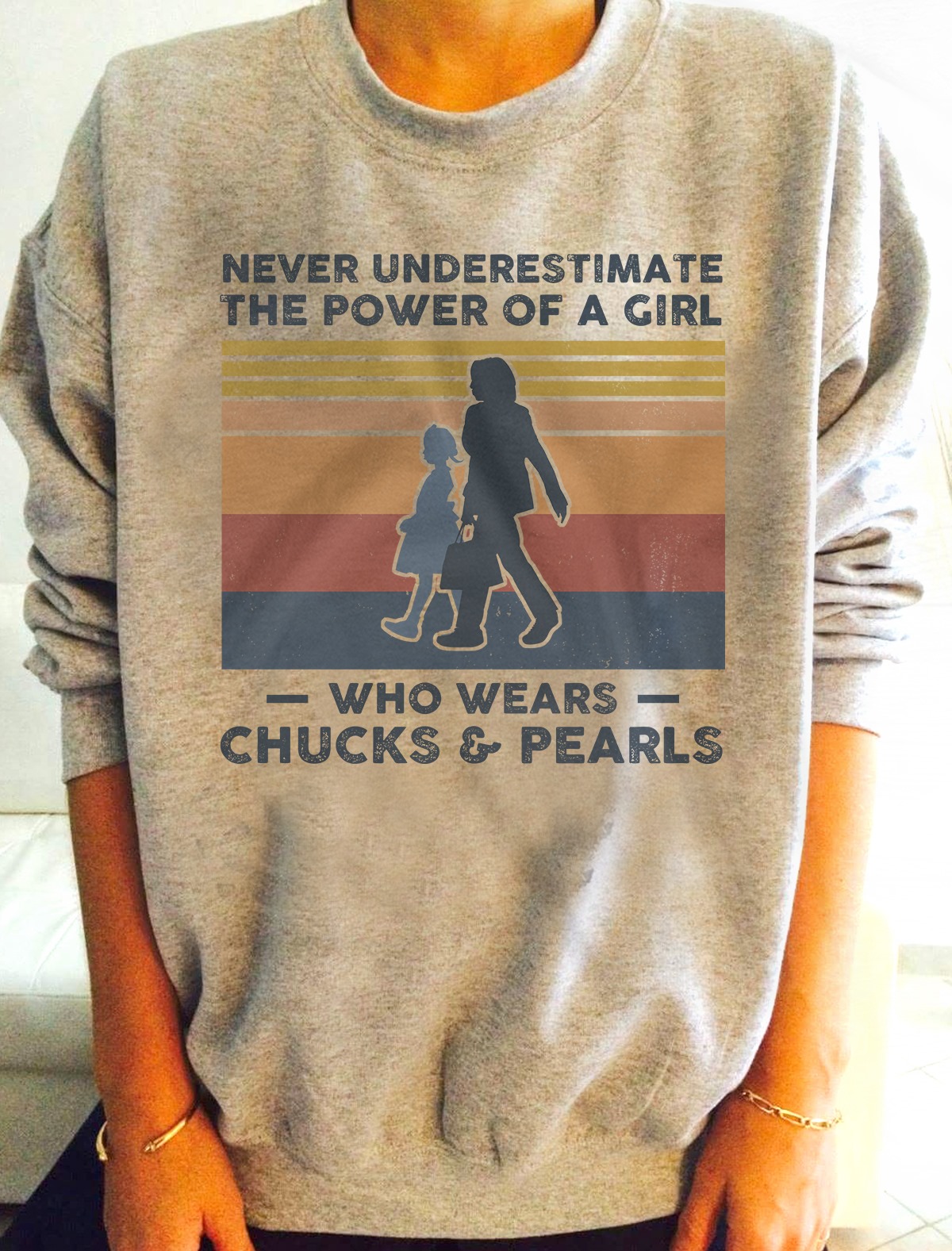 Never underestimate the power of a girl who wears chucks and pearls