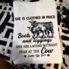 Cow Lover - She is clothed in muck boots and legging and she laughs without fear at the cow