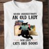 Never underestimate an old lady who loves cats and books - Black cat reading book, old lady bookaholic